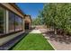 Lush backyard with a covered patio, outdoor grill, and artificial turf at 12360 W Eagle Ridge Ln, Peoria, AZ 85383
