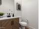 Chic half bathroom features wood-grain vanity with black fixtures at 12360 W Eagle Ridge Ln, Peoria, AZ 85383
