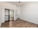 Bedroom featuring wood-look floors and a mirrored closet at 12360 W Eagle Ridge Ln, Peoria, AZ 85383