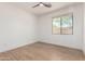 Bright bedroom with wood-look floors and a large window with a view at 12360 W Eagle Ridge Ln, Peoria, AZ 85383