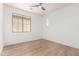 Bright bedroom with wood-look floors and window offering natural light at 12360 W Eagle Ridge Ln, Peoria, AZ 85383