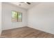 Bedroom featuring wood-look floors and a large window with a view at 12360 W Eagle Ridge Ln, Peoria, AZ 85383