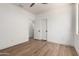 Bedroom with wood-look floors, ceiling fan, and a double door at 12360 W Eagle Ridge Ln, Peoria, AZ 85383