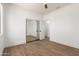 Bedroom featuring wood-look floors and a mirrored closet at 12360 W Eagle Ridge Ln, Peoria, AZ 85383