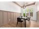 Cozy dining room features modern finishes, wainscoting detail, and a stylish chandelier at 12360 W Eagle Ridge Ln, Peoria, AZ 85383