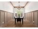 Elegant dining room with wainscoting, modern chandelier, and ample natural light at 12360 W Eagle Ridge Ln, Peoria, AZ 85383
