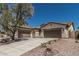 A long driveway leads to a 3 car garage on this single story home with desert landscaping at 12360 W Eagle Ridge Ln, Peoria, AZ 85383