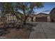 Inviting single-story home featuring a desert-landscaped front yard, private gated entry and spacious three car garage at 12360 W Eagle Ridge Ln, Peoria, AZ 85383