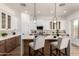 Stylish kitchen features a large island with seating, modern lighting, and two-tone cabinetry at 12360 W Eagle Ridge Ln, Peoria, AZ 85383