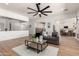 Spacious living room featuring open layout, wood floors, and a clear view into the updated kitchen at 12360 W Eagle Ridge Ln, Peoria, AZ 85383