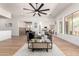 Inviting living room boasts modern decor, wood floors, and seamless connection to the kitchen at 12360 W Eagle Ridge Ln, Peoria, AZ 85383