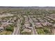 High aerial view showcases a vibrant community featuring lush desert landscaping and well-maintained streets at 12360 W Eagle Ridge Ln, Peoria, AZ 85383
