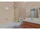 Bathroom featuring a toilet, tub, shower with coordinated fixtures, and a single sink vanity and a mirror at 13657 W Holly St, Goodyear, AZ 85395