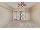 Well lit room has carpet, ceiling fan, and ample space, along with a cased opening to another room at 13657 W Holly St, Goodyear, AZ 85395