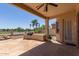 A covered patio provides views of the lush greenery and community golf course at 13657 W Holly St, Goodyear, AZ 85395