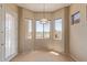 Bright dining area with large windows offering views of the golf course at 13657 W Holly St, Goodyear, AZ 85395