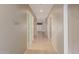 Inviting hallway featuring neutral paint, tile flooring, and doorways to living spaces at 13657 W Holly St, Goodyear, AZ 85395