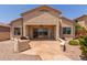 Spacious backyard with a covered patio, desert landscaping, and an outdoor cooking area perfect for entertaining at 13657 W Holly St, Goodyear, AZ 85395