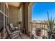Relaxing balcony with seating and potted cacti offers scenic views of the neighborhood at 14575 W Mountain View Blvd # 12309, Surprise, AZ 85374