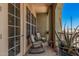 Charming balcony with comfortable rocking chairs and a variety of potted plants for outdoor enjoyment at 14575 W Mountain View Blvd # 12309, Surprise, AZ 85374