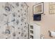 Cozy bathroom features seashell-themed shower curtain and beach decor for a relaxed, coastal atmosphere at 14575 W Mountain View Blvd # 12309, Surprise, AZ 85374