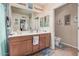 Well-maintained bathroom with a double sink vanity, a large mirror, and a separate toilet area at 14575 W Mountain View Blvd # 12309, Surprise, AZ 85374