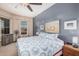 Bright bedroom with a comfortable bed, ceiling fan, window with blinds, and a blue accent wall at 14575 W Mountain View Blvd # 12309, Surprise, AZ 85374