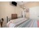 Bedroom featuring comfortable bed, a TV mounted on the wall, a ceiling fan, and plenty of natural light at 14575 W Mountain View Blvd # 12309, Surprise, AZ 85374