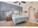 Comfortable bedroom with a blue accent wall, ceiling fan, carpet flooring and plenty of natural light at 14575 W Mountain View Blvd # 12309, Surprise, AZ 85374