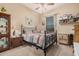 Bedroom with a ceiling fan, window with blinds, and ample storage with side table and a display cabinet at 14575 W Mountain View Blvd # 12309, Surprise, AZ 85374