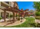 Beautiful community area with a wooden pergola, picnic tables, and well-maintained landscaping at 14575 W Mountain View Blvd # 12309, Surprise, AZ 85374