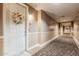 Hallway with carpeting, neutral walls, and a decorative wreath on the apartment door at 14575 W Mountain View Blvd # 12309, Surprise, AZ 85374