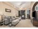 Inviting living room with a gray sectional sofa, ceiling fan, and access to a balcony at 14575 W Mountain View Blvd # 12309, Surprise, AZ 85374