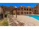 Relaxing community pool area featuring lounge chairs and a shaded pergola for comfortable outdoor lounging at 14575 W Mountain View Blvd # 12309, Surprise, AZ 85374