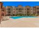 Well-maintained community pool surrounded by comfortable lounge chairs and attractive residential buildings at 14575 W Mountain View Blvd # 12309, Surprise, AZ 85374