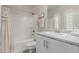 Bathroom featuring a tub with shower, vanity, and decorative mirror and sconces at 14759 W Alexandria Way, Surprise, AZ 85379