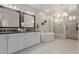 Bright bathroom with double vanity, standalone tub, and tiled shower at 14759 W Alexandria Way, Surprise, AZ 85379