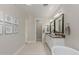 Bathroom with dual sinks, tiled floors, and modern lighting at 14759 W Alexandria Way, Surprise, AZ 85379