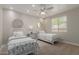 Bedroom with two twin beds, light neutral colored walls and ceiling fan at 14759 W Alexandria Way, Surprise, AZ 85379