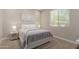 Bright bedroom features carpet, white trim and light neutral color palette at 14759 W Alexandria Way, Surprise, AZ 85379