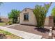 Attractive single-story home with low-water landscaping, tile roof, and neutral-toned exterior at 14759 W Alexandria Way, Surprise, AZ 85379