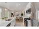 Modern kitchen connects seamlessly to the dining and living spaces, featuring white cabinetry and stainless appliances at 14759 W Alexandria Way, Surprise, AZ 85379