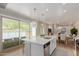 Kitchen island with a sink, stainless steel appliances, and a view of the covered patio at 14759 W Alexandria Way, Surprise, AZ 85379