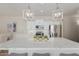 Bright kitchen with white cabinets, stainless appliances, and large quartz island at 14759 W Alexandria Way, Surprise, AZ 85379