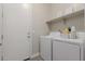 Bright laundry room featuring white washer and dryer, and shelving at 14759 W Alexandria Way, Surprise, AZ 85379