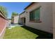 Inviting backyard pool with artificial turf and attractive water feature for ultimate relaxation at 14759 W Alexandria Way, Surprise, AZ 85379