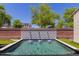 Tranquil pool with a unique brick and tile water feature for an enhanced outdoor experience at 14759 W Alexandria Way, Surprise, AZ 85379