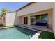 Relaxing backyard with pool, lounge seating and convenient sliding glass doors at 14759 W Alexandria Way, Surprise, AZ 85379