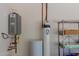 Utility room with water heater, water softener, and storage shelving at 14759 W Alexandria Way, Surprise, AZ 85379