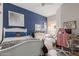 Charming bedroom featuring a blue accent wall, white furniture, and natural light from the window seat at 14806 E Crested Crown --, Fountain Hills, AZ 85268